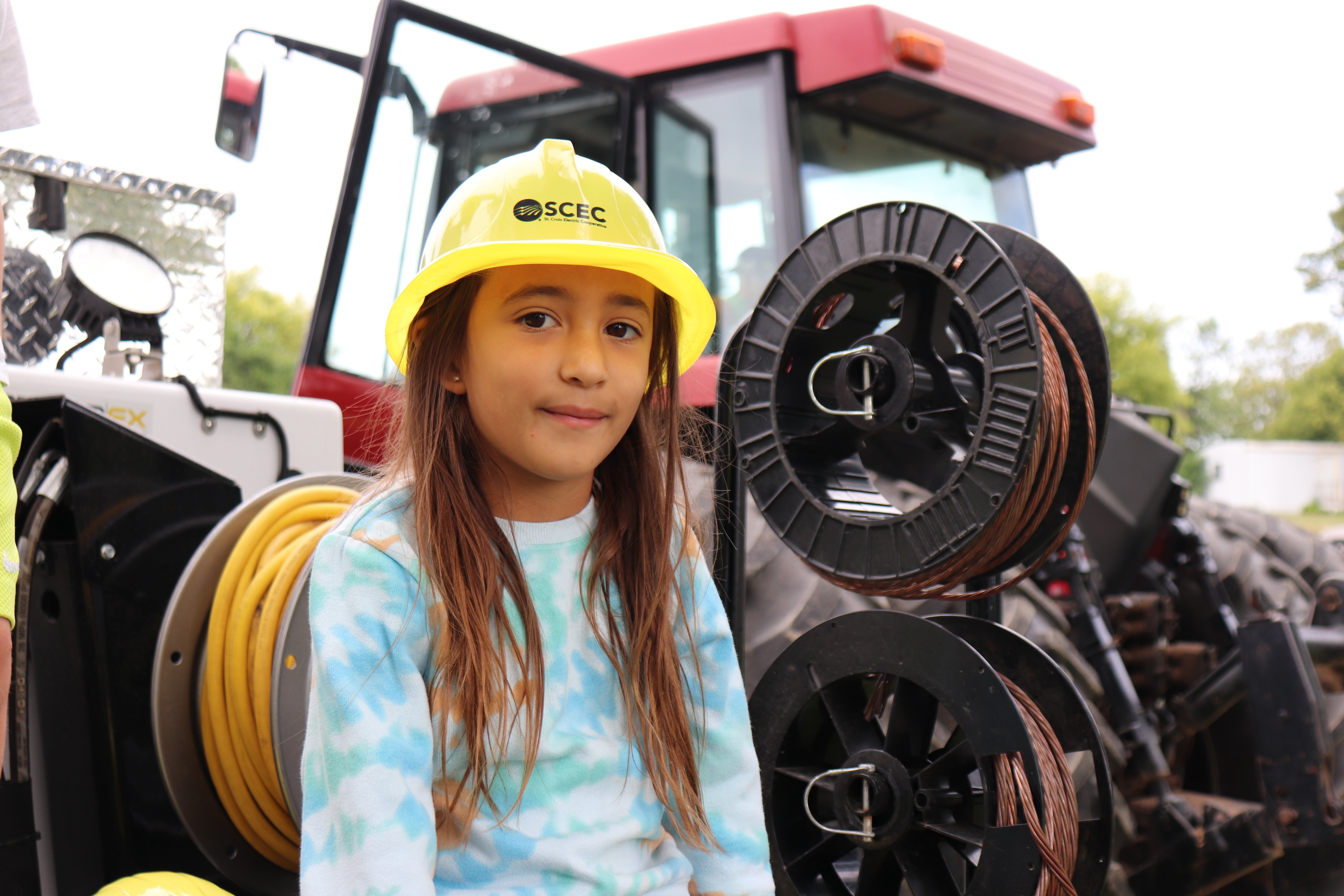 girl in yellow hat on bucket truck 